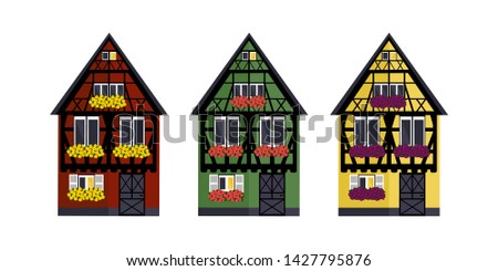 Three houses of different colors in Alsaces style. Green, red and yellow houses in Alsaces style.