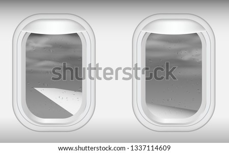 view of windows of plane in on the sky in the rain 