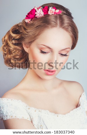 portrait of the beautiful young girl in an image of the bride with ornament in hair