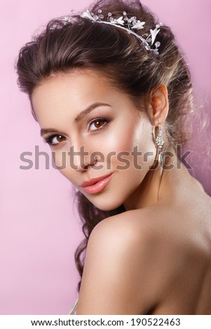 Beautiful young girl with a floral ornament in her hair.Youth and Skin Care Concept