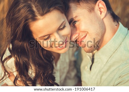 Young couple in love outdoor.Stunning sensual outdoor portrait of young stylish fashion couple posing in summer in field.Couple hugging