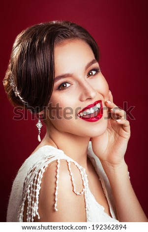 portrait of the beautiful young girl in an image of the bride with ornament in hair.Beautiful young model with red lips.Woman with Perfect Makeup. Red Lips .  Glamorous Woman.