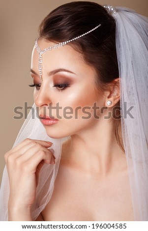 Beautiful young girl with a diadem in her hair. Youth and Skin Care Concept. Wedding. Young Gentle Quiet Bride in Classic White Veil. Portrait of beautiful bride. portrait in profile