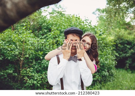 Young couple in love outdoor. They are smiling and looking at each other.Happy Smiling Couple in love.Stunning sensual outdoor portrait of young stylish fashion couple posing in summer in park