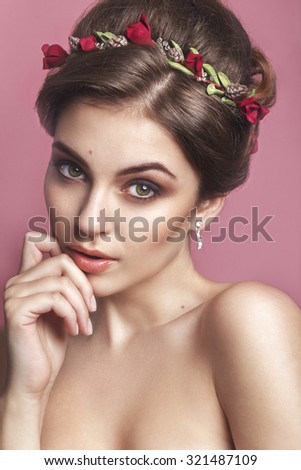 Beautiful young girl with a floral ornament in her hair.Beautiful Woman Touching her Face. Youth and Skin Care Concept
