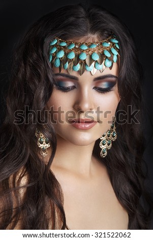 Oriental style. Sensual arabic woman model. Beautiful clean skin, saturated makeup. Bright eye make-up and dark eyeliner.Arab woman. Beautiful creative makeup.