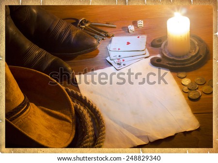 American west background with poker cards and cowboy clothes.Old paper for text