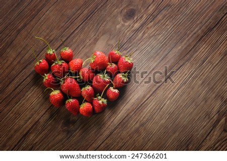 Strawberry on Wooden texture for background, Valentines Day Heart Made of Strawberry