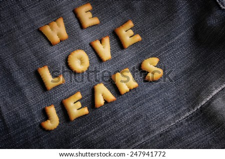 Cookies ABC in the form of word WE LOVE JEANS alphabet on old jean background, Valentines day