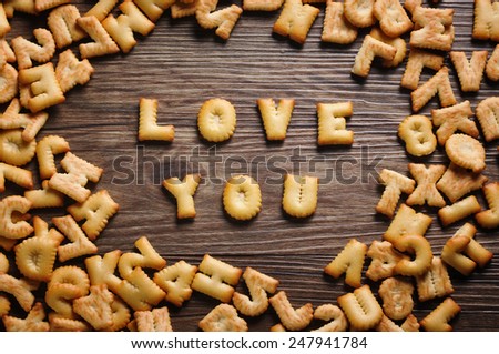 Cookies ABC in the form of word LOVE YOU alphabet on wooden background, Valentines day