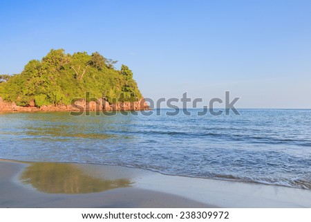 Background stone beach, with blue sky and sand