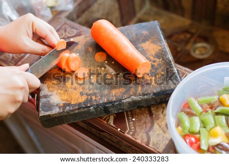 female\'s hand cutting vegetable for making food