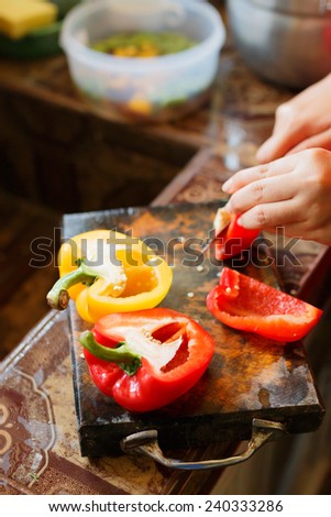 female's hand cutting vegetable for making food
