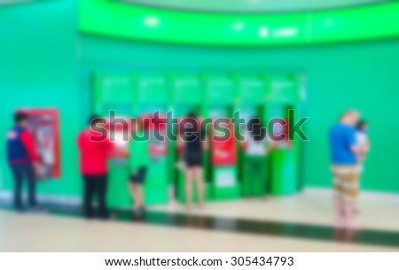 Blurred image of people use ATM machine for take money.
