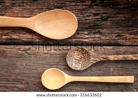 Empty wooden spoon put on wooden table.