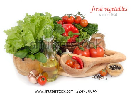 Fresh vegetables in wooden ware on a white background.