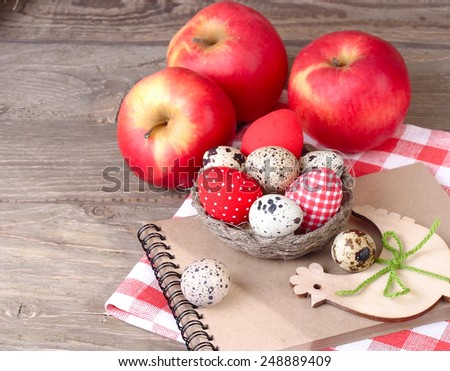 Easter background with eggs, apples and wooden chicken.