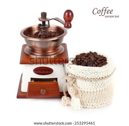 The manual coffee grinder and coffee grains in a knitted bag on a white background.