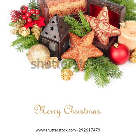 Golden stars in wooden chests, candles and other Christmas-tree decorations on branches of a Christmas tree on a white background. A Christmas background with a place for the text.