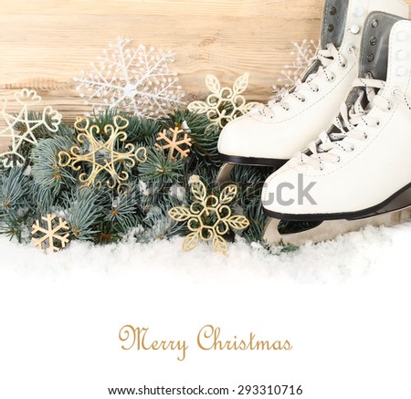 The white figured skates and decorative snowflakes on branches of a Christmas tree on a white background. A Christmas background with a place for the text.