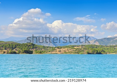 View of the coast and the mountains from the water side.