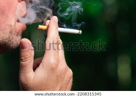 Similar – Image, Stock Photo Young man smoking cigarette in the night