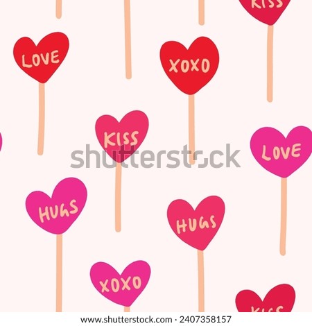 Cute love lollipops arranged in a color palette of red, cream and pink on off white background forming a seamless vector pattern. Great for homedecor,fabric,wallpaper,giftwrap,stationery,packaging.