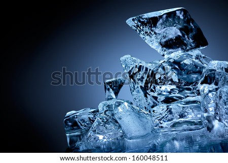 Block of frozen ice with blue toned background.