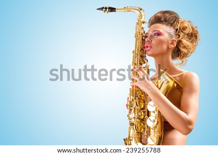 Retro photo of a sleepy nude pin-up woman with closed vintage winged eyes, hugging a saxophone like a tender lover on blue background.