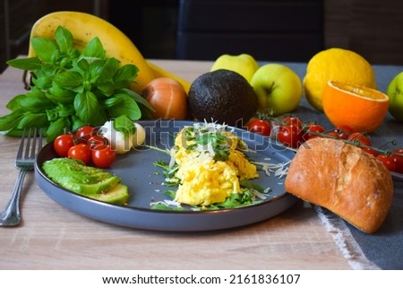 French omelette dish. Delicous homemade french omlette filled with cheese. Plating with fresh vegetables like avocado, cherry tomatoes, but also basil and mozzarella. Stock fotó © 