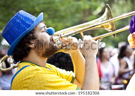 NITEROI, BRAZIL - MAY 6, 2012: People in costumes playing instruments while taking part in a Carnival-like parade, celebrating the anniversary of a local street band. May 6, 2012 in Niteroi, Brazil