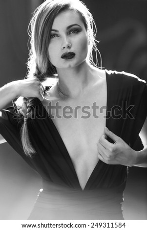 Blonde woman wearing black dress black and white