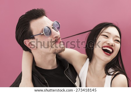 Funny man wearing lipstick and his laughing girlfriend