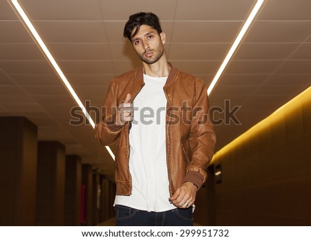Man in the subway undoing the jacket zip