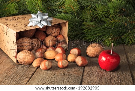 Fruits falling from gift box on wooden plank