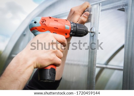 Similar – Image, Stock Photo Farmer repairing detail of agricultural machine