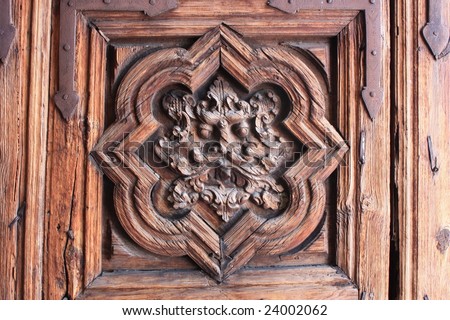 Spirit face & wrought-iron reinforcing plates on ancient carved wood door; Morelia, Mexico
