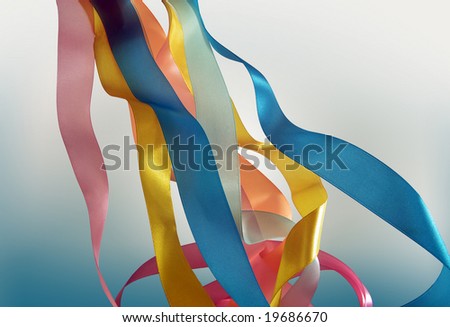 Color tapes on a blue background. A holiday of spring, a symbol of a carnival