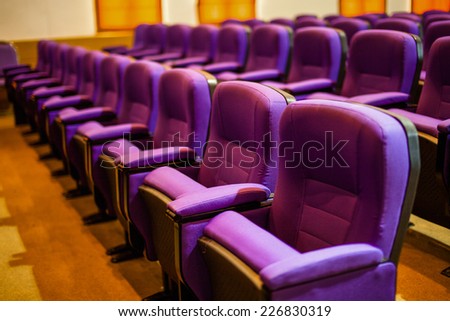 Empty hall for presentation with purple armchairs