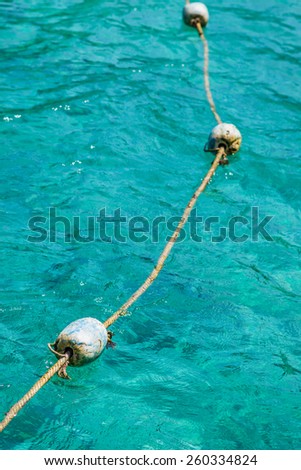 buoy rope barrier on the water with floats