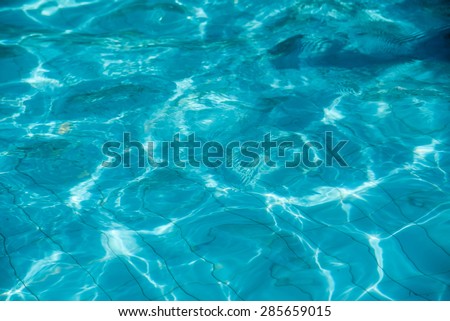isolation Azure water outdoor swimming pool with reflections of sunlight