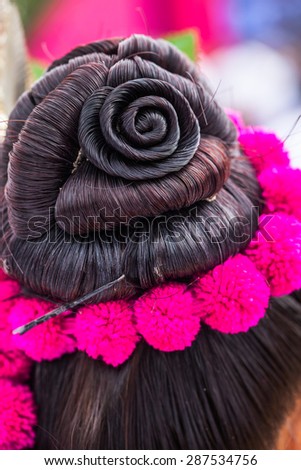 Thai woman with hair bun and flower