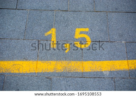 Yellow marking on street in order to guide social distancing due to coronavirus or covid-19 pandemic. Yellow marking indicating how much distance people should keep to be safe. 1.5 meters, lockdown ストックフォト © 