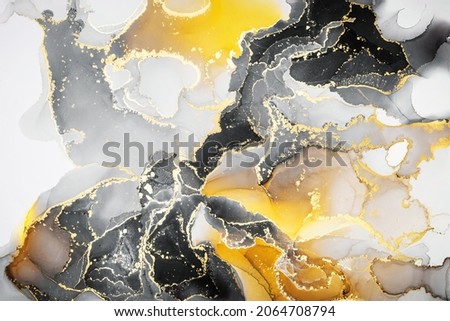 Abstract fluid art painting background in alcohol ink technique, mixture of vivid yellow black and gold paints. Imitation of marble agate slice texture.