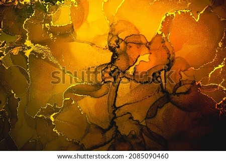 Abstract fluid art painting background in alcohol ink technique, mixture of yellow and golden metallic paints. Transparent overlayers of ink create lines and gradients. Burst of creativity.