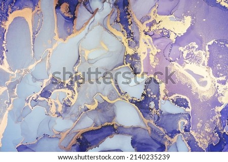 Luxury abstract painting in fluid art technique.Transparent layers of vivid lilac and gold paints create marbled texture of stripes, swirls and veins with glowing gold and glitter. Natural beauty