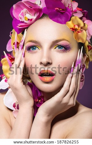 Beautiful woman with hair made of flowers and long nails
