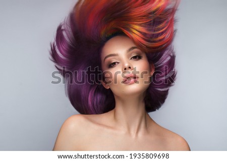 Beautiful woman with multi-colored hair and creative make up and hairstyle. Beauty face.
