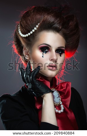Girl in gothic art style with creative makeup,drop on her face