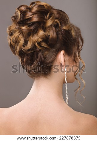 Girl with evening or wedding hairstyle. Picture taken in a studio.